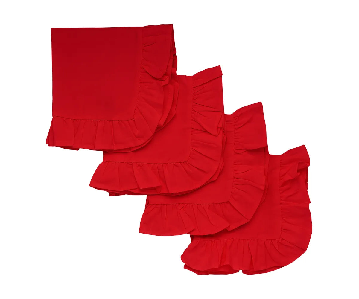 Red ruffle edge cotton dinner napkins folded on a dining table