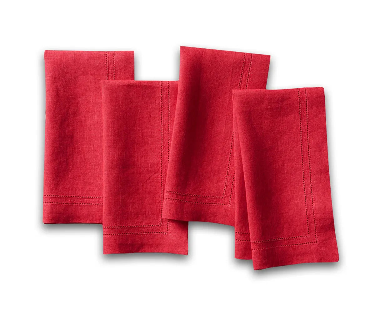 Elegant red hemstitch linen napkins neatly folded on a dining table