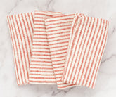 Red striped napkins folded and stacked for storage or display