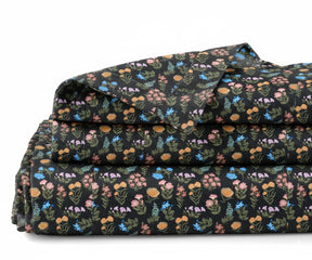 dark floral linen sheet set with vibrant botanical print on black background, breathable flax linen bedding for queen and king size beds