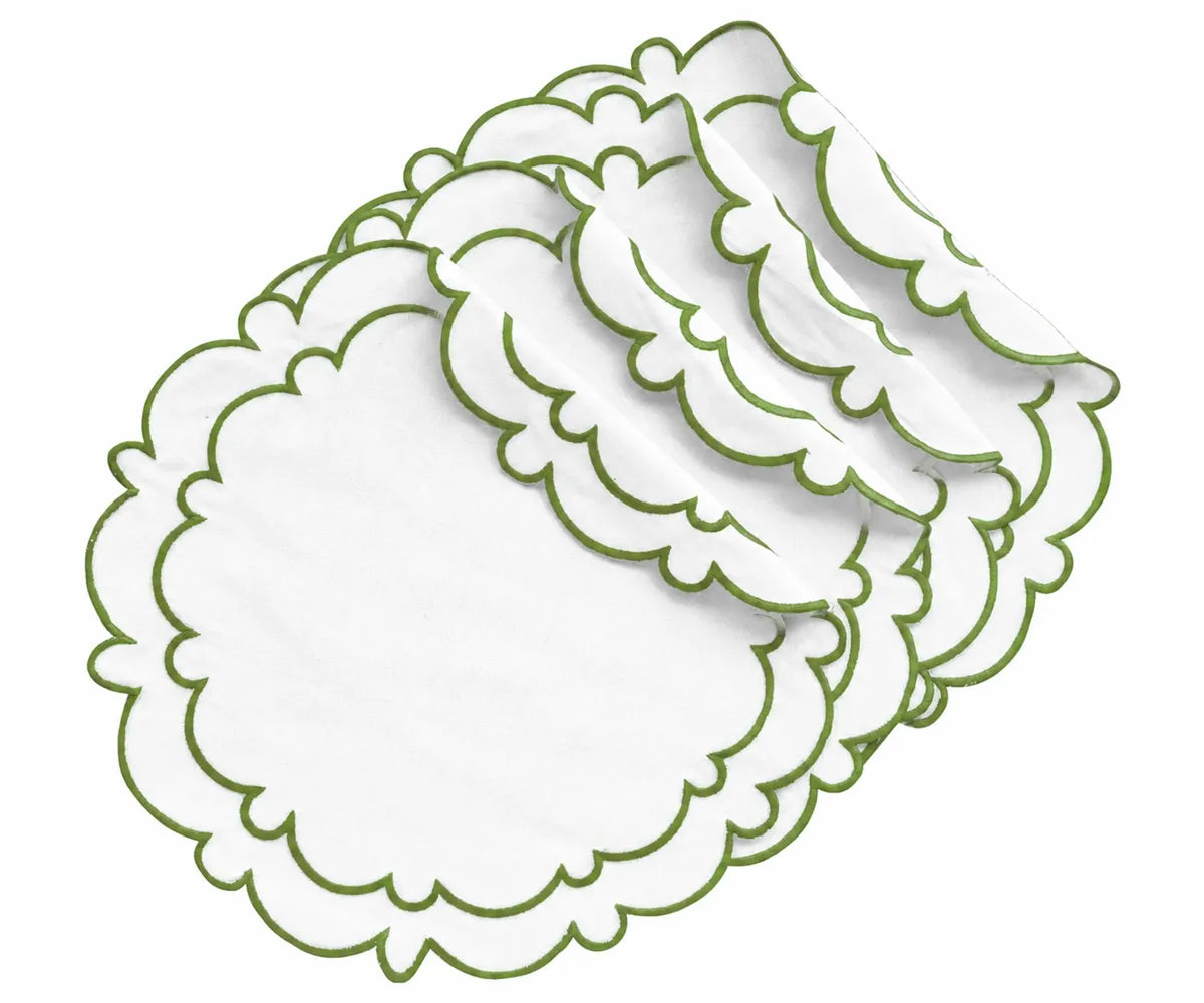 White cotton round scalloped edge placemats with sage green trim, displayed in a layered stack for elegant dining table decor.