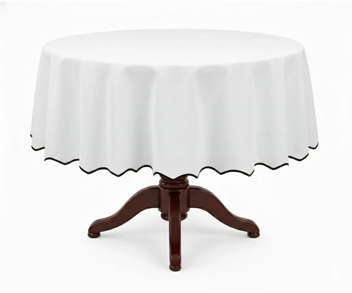 White round cotton tablecloth with a contrasting black scalloped edge, made from 100% cotton for a smooth, elegant drape. This white tablecloth with black trim suits round dining tables, blending modern and classic décor styles, ideal for everyday dining, formal dinners, weddings, and special occasions.