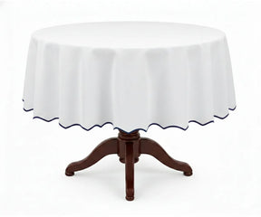 White round cotton tablecloth with a deep navy blue scalloped edge, made from premium 100% cotton for a smooth and polished drape. This white tablecloth with navy trim adds sophistication to round dining tables, suitable for formal dinners, holiday settings, weddings, and special occasions.