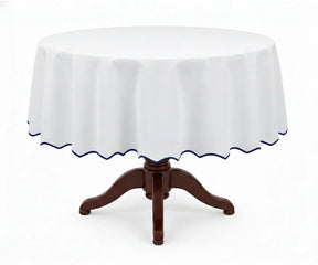 White round cotton tablecloth featuring a blue scalloped edge, designed from 100% cotton to provide a clean and refined look. This white tablecloth with blue trim enhances modern and traditional dining spaces, ideal for everyday meals, celebrations, weddings, and stylish table settings.