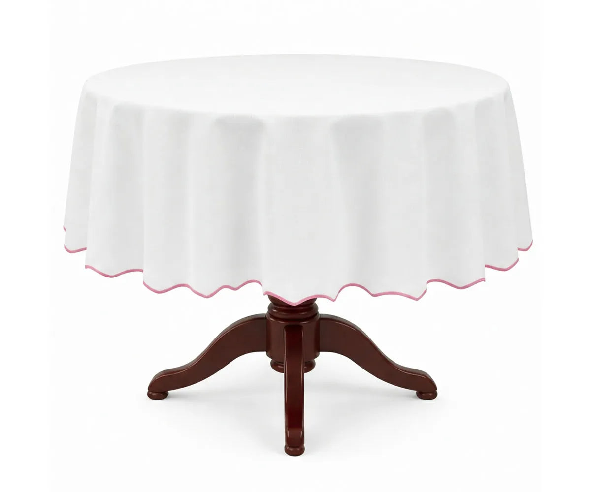 White round cotton tablecloth with a delicate pink scalloped edge, made from 100% cotton for a soft, flowing drape. This white tablecloth with pink trim adds charm to dining tables, perfect for brunches, baby showers, weddings, special occasions, and everyday elegant décor.