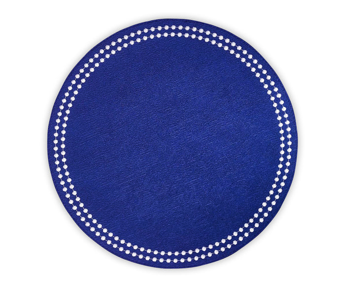 Set of 4 embroidered blue and white cotton placemats styled for a table setting