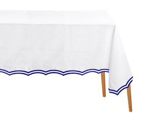 Royal blue rectangle tablecloth with scalloped embroidered edges on dining table