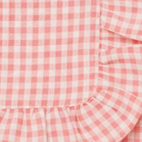 Decorative blush pink checked cotton napkin with ruffle trim
