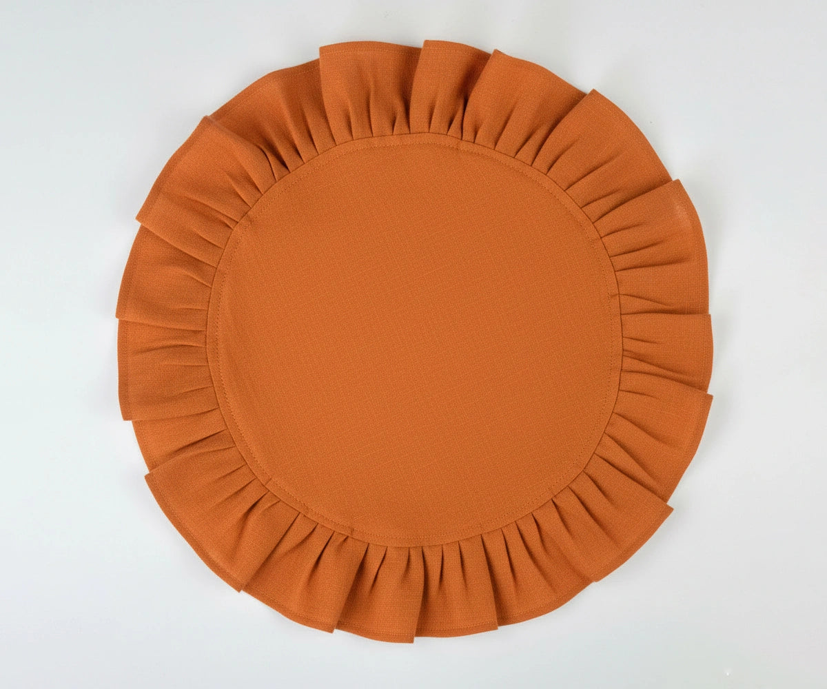 Rust round cotton napkins with decorative ruffled edges, adding warmth and character to neutral tableware.