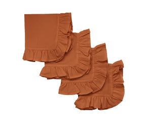 Rust ruffle edge cotton cloth napkins set on a dining table