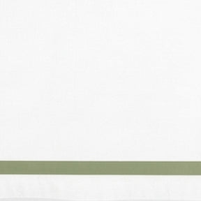 Close-up detail of white cotton pillowcase with a sage green border line.