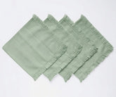 Woven cotton cloth napkins with decorative fringe borders, designed for both everyday dining and formal table arrangements.
