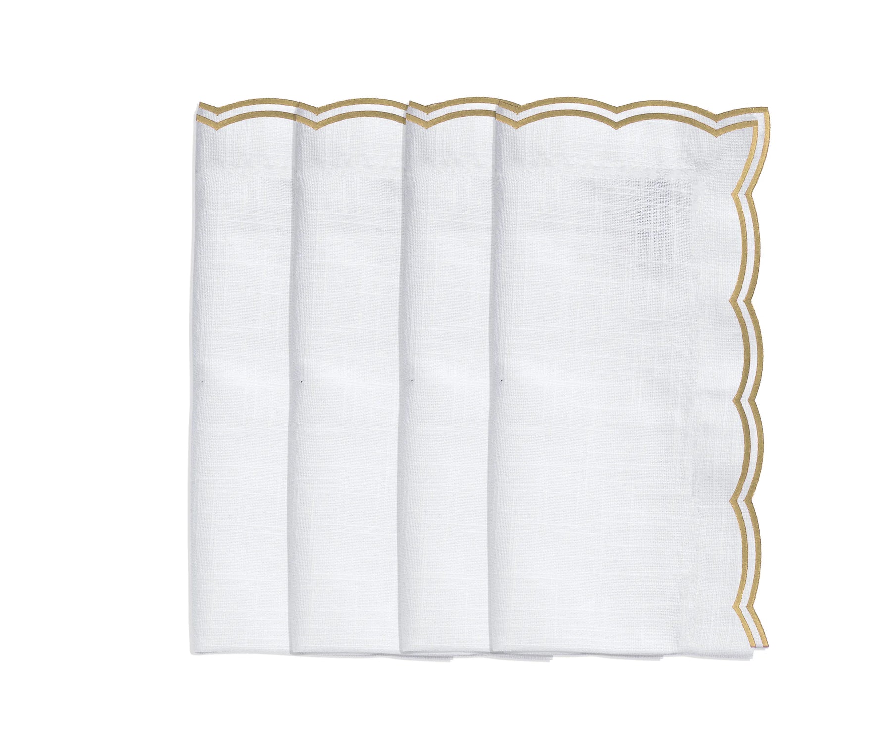Set of 4 beige embroidered napkins styled with a matching scalloped tablecloth