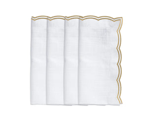 Set of 4 beige embroidered napkins styled with a matching scalloped tablecloth