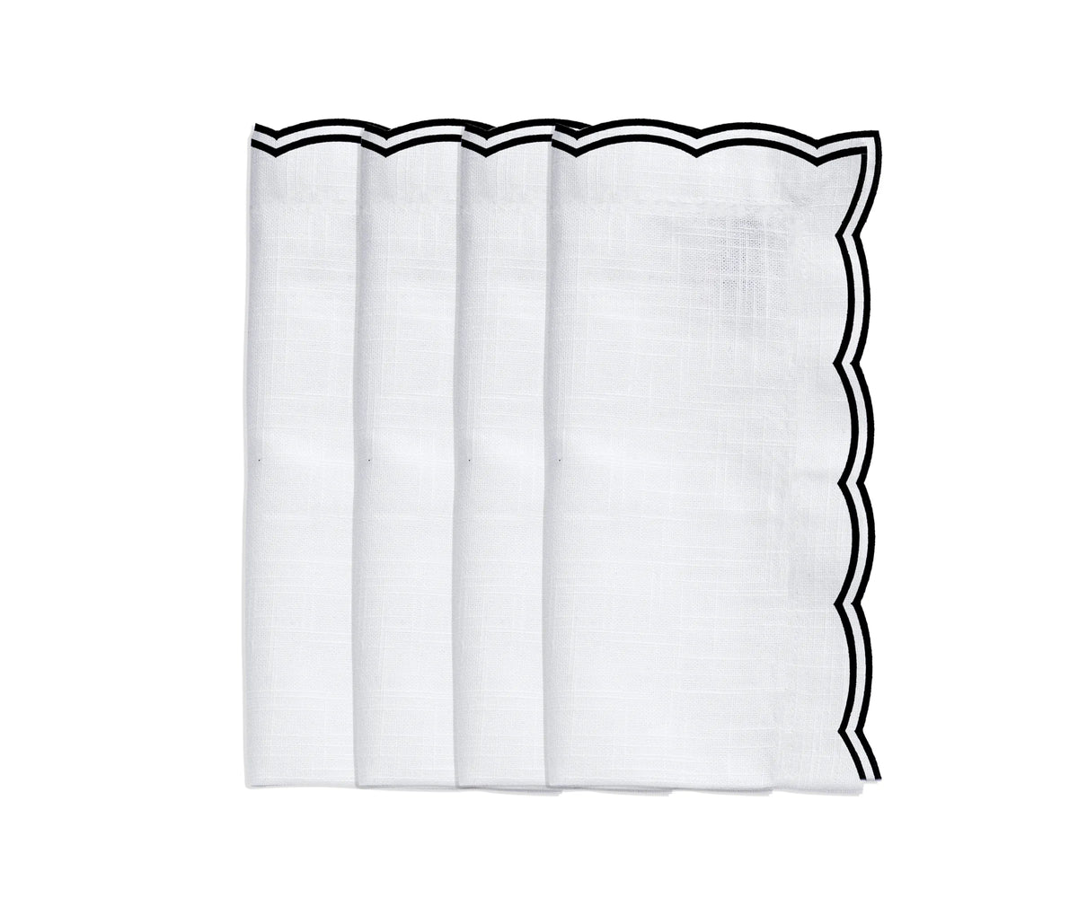 Black scalloped edge napkins placed on a formal dinner setting