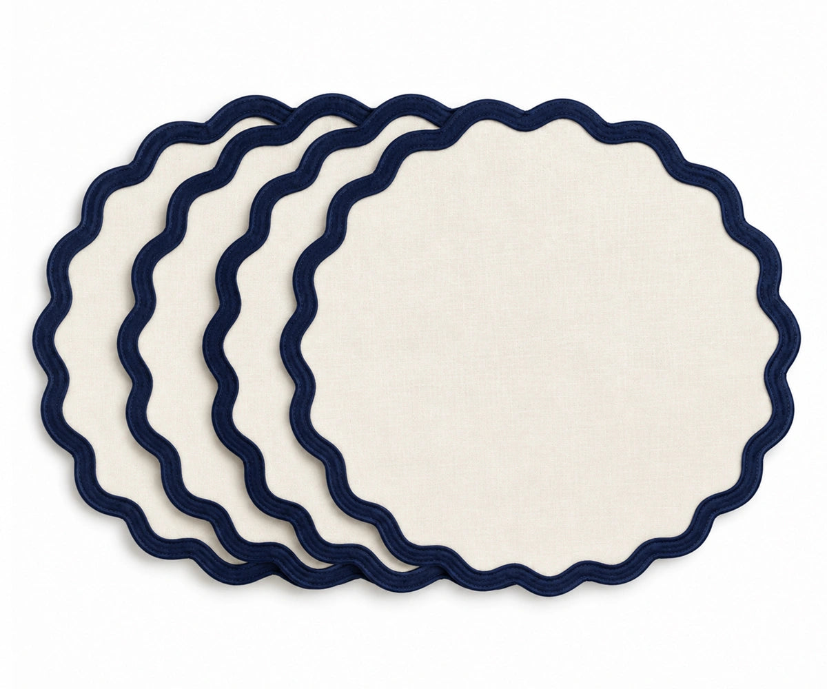 Ivory cotton dining placemat featuring a navy blue scalloped border, reusable table accessory for coastal, nautical, farmhouse, traditional, and classic home dining table decor