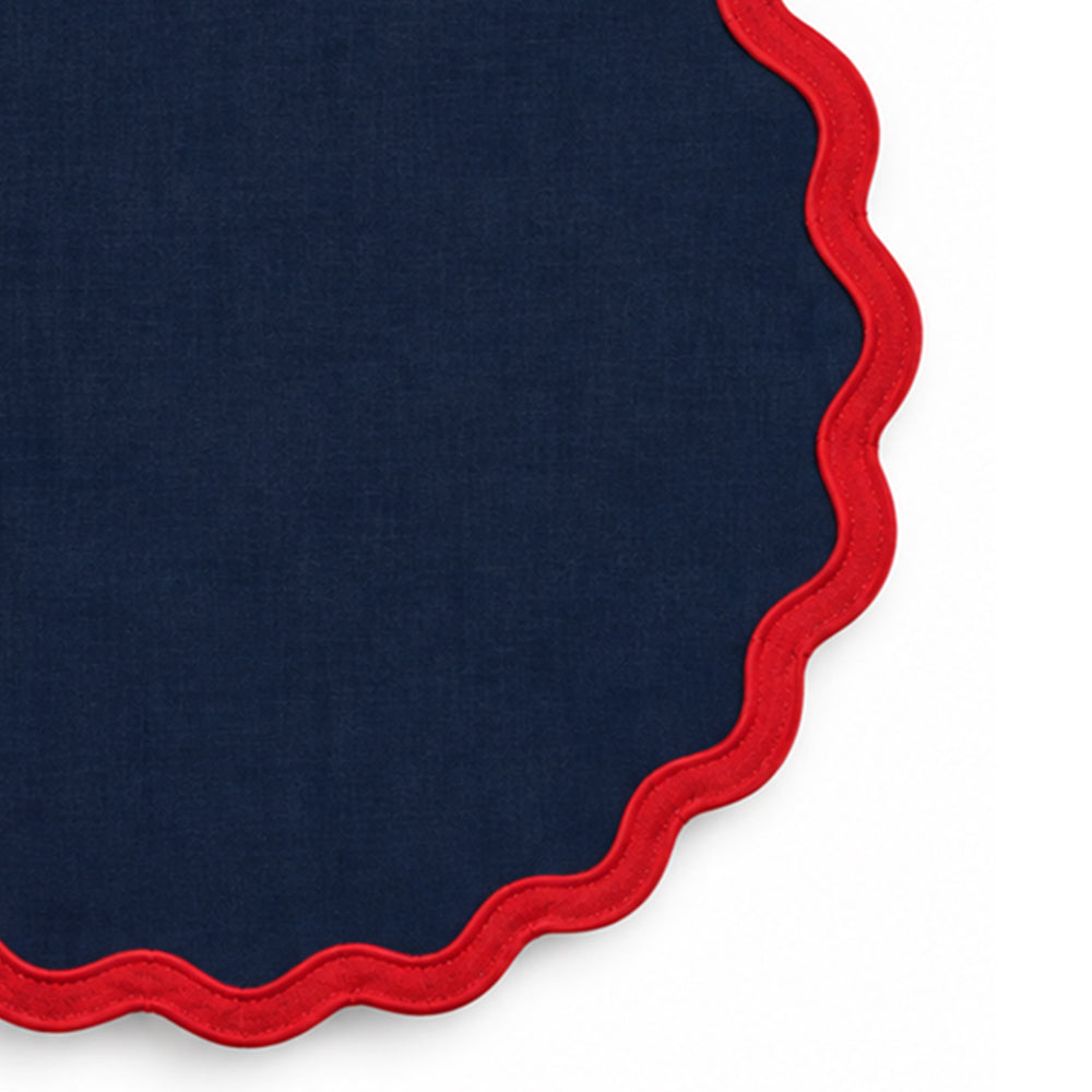 Navy blue cotton dining placemat featuring a contrasting red scalloped border, reusable table accessory for farmhouse, traditional, coastal, and special occasion dining decor