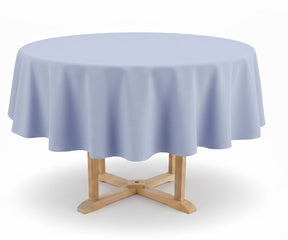 Round table with a light blue tablecloth on a white background