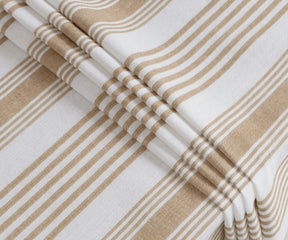 Beige and white striped rectangular tablecloth with elegant drape on dining table