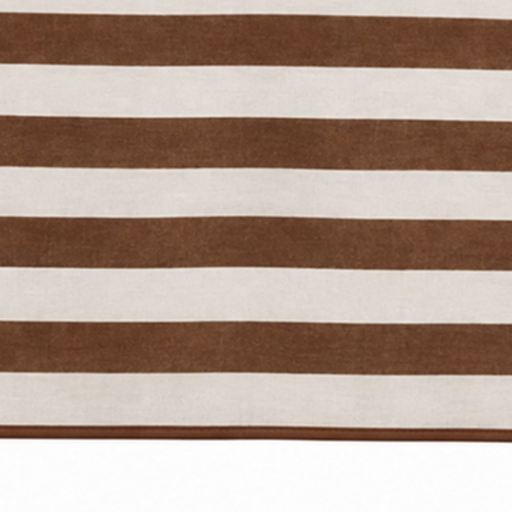 A close-up of a striped textile or rug with alternating horizontal bands of medium brown and warm off-white.