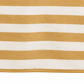 A close-up of a striped textile with alternating warm yellow and off-white horizontal bands, showing a soft woven texture and a stitched edge along the bottom.
