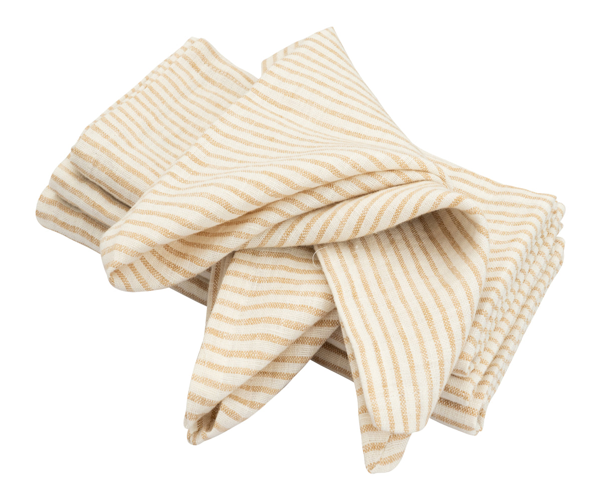 100% pure linen napkins styled beside a plate and cutlery for an elegant table setting