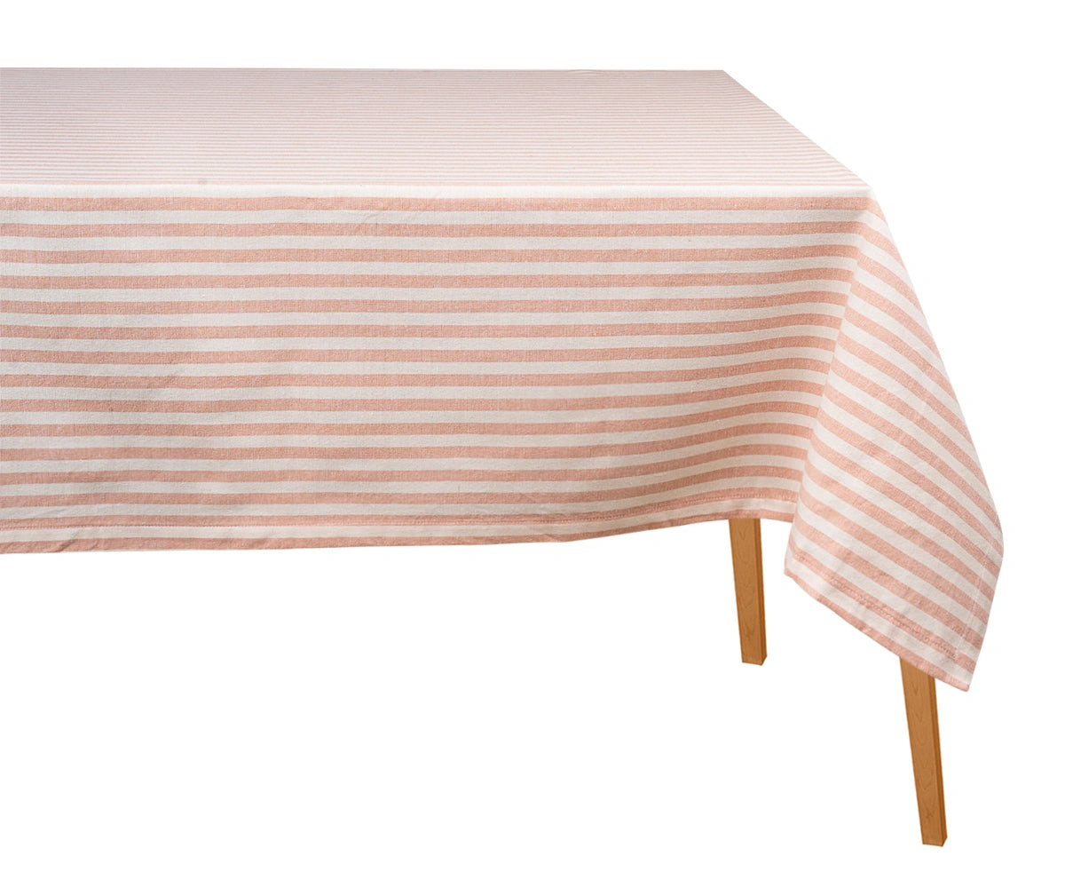 Orange and white striped cotton tablecloth draped over a wooden dining table against a plain white background.