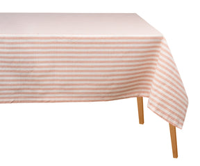 Orange and white striped cotton tablecloth draped over a wooden dining table against a plain white background.