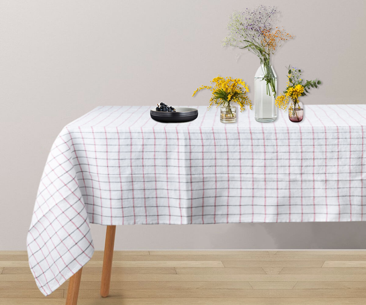A round linen tablecloth in a calming white hue.