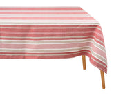 Red striped cotton tablecloth draped over a wooden dining table against a plain white background.