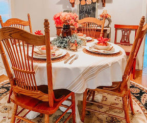 Outdoor dining setup featuring a round table with the outdoor tablecloth