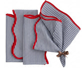 Blue and white striped cotton napkins with red edge detail, reusable washable dinner napkins styled on a dining table with coordinating striped tablecloth.