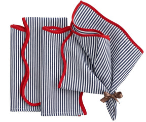 Blue and white striped cotton napkins with red edge detail, reusable washable dinner napkins styled on a dining table with coordinating striped tablecloth.