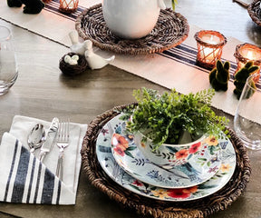 Elegant black and white striped dinner napkins paired with matching striped tablecloth for coordinated table décor