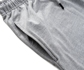  Comfortable grey shorts styled with a white t-shirt, ideal for casual men’s summer outfits