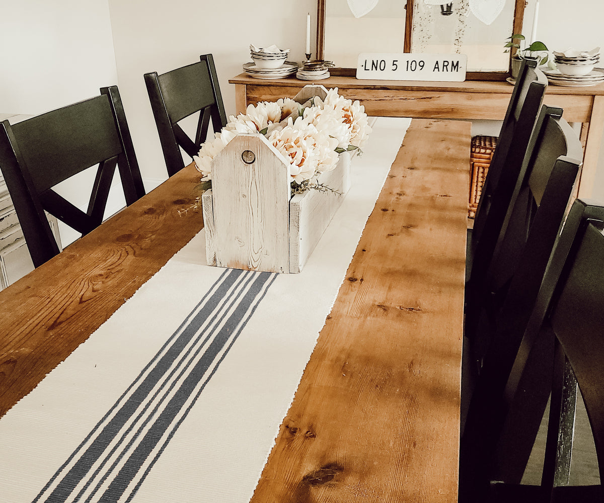 Elevate your decor with a striped table runner, blending tradition and modernity.