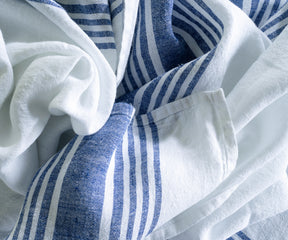Blue and white striped linen tablecloth laid out on a table for contrast