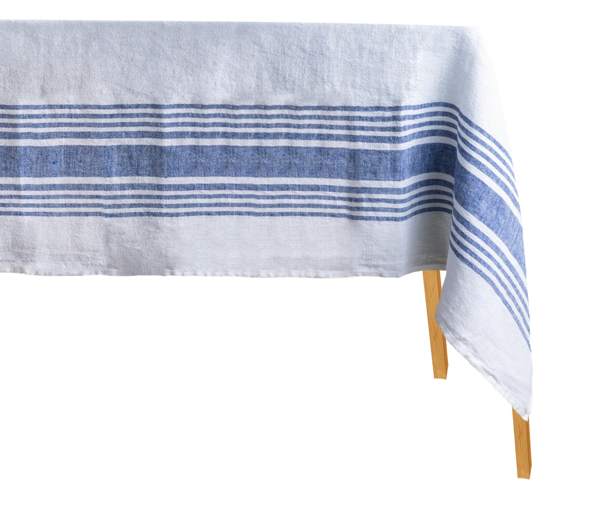 Nautical-themed blue and white striped linen tablecloth on a wooden surface
