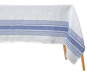 Classic blue and white striped linen tablecloth on a rustic wooden table