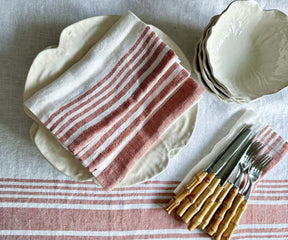 White linen tablecloth on a table with modern tableware