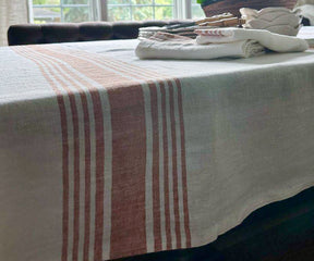 White linen tablecloth on a table with a centerpiece