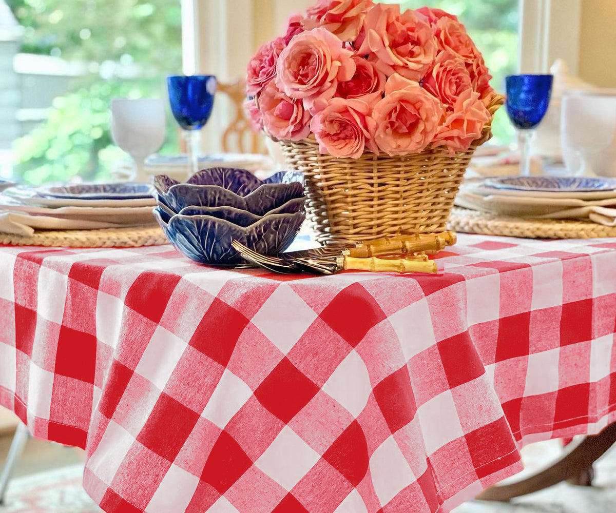 Red and white plaid tablecloth with fresh watermelon slices on picnic table