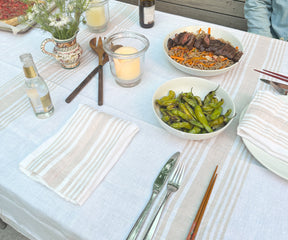 White linen tablecloth draped over a table creating an elegant setting