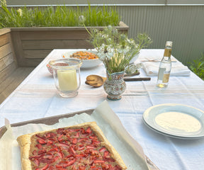 White linen tablecloth on a table with simple decor