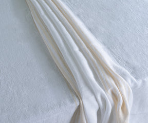 Elegant white linen tablecloth on a dining table