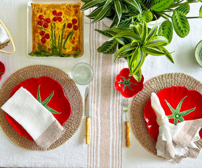 Dining table adorned with a crisp white and subtle red striped linen tablecloth