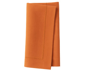 Vibrant tangerine napkin crafted from soft cotton, perfect for everyday meals and parties.