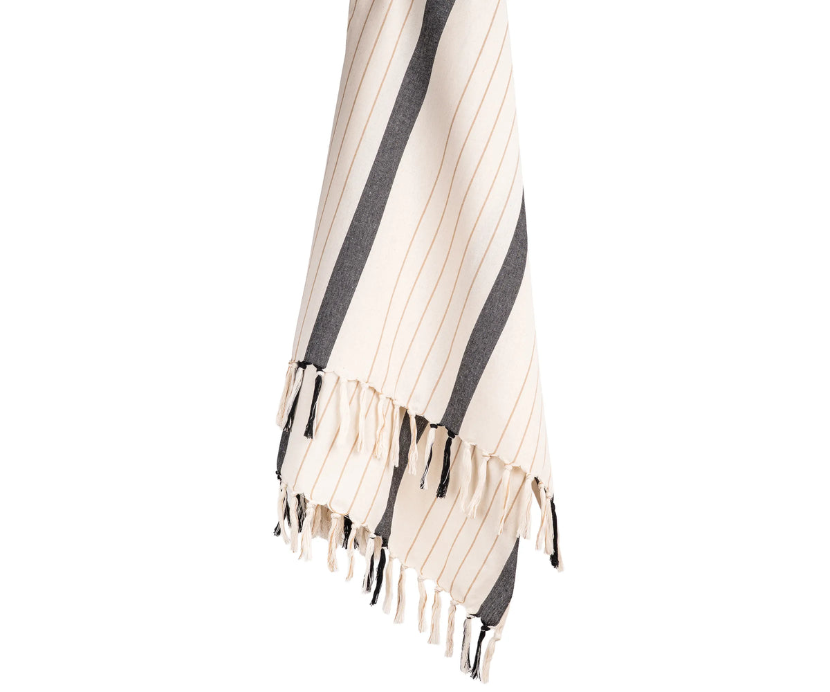 Soft cotton throw blanket with classic black and white stripes and subtle accents, styled for a modern living room
