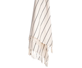 Black and white striped cotton throw blanket styled on a sofa, adding a clean and modern touch