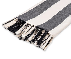 Modern black and white cotton throw blanket folded on a chair, suitable for sofas or beds